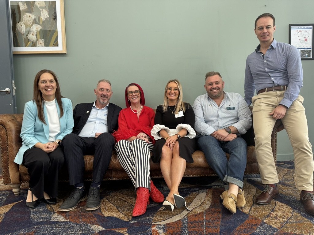 Tracy Sheen with the Greater Springfield Chamber of Commerce committee on a couch at Springlake Hotel after the workshop