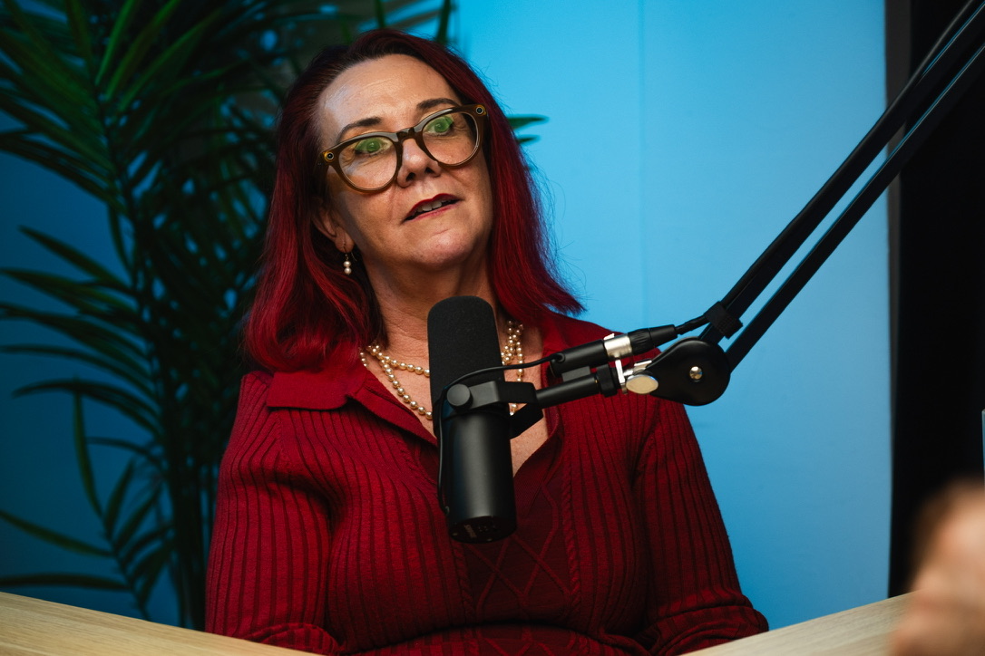 Tracy Sheen behind the microphone in The Mentor podcast studio
