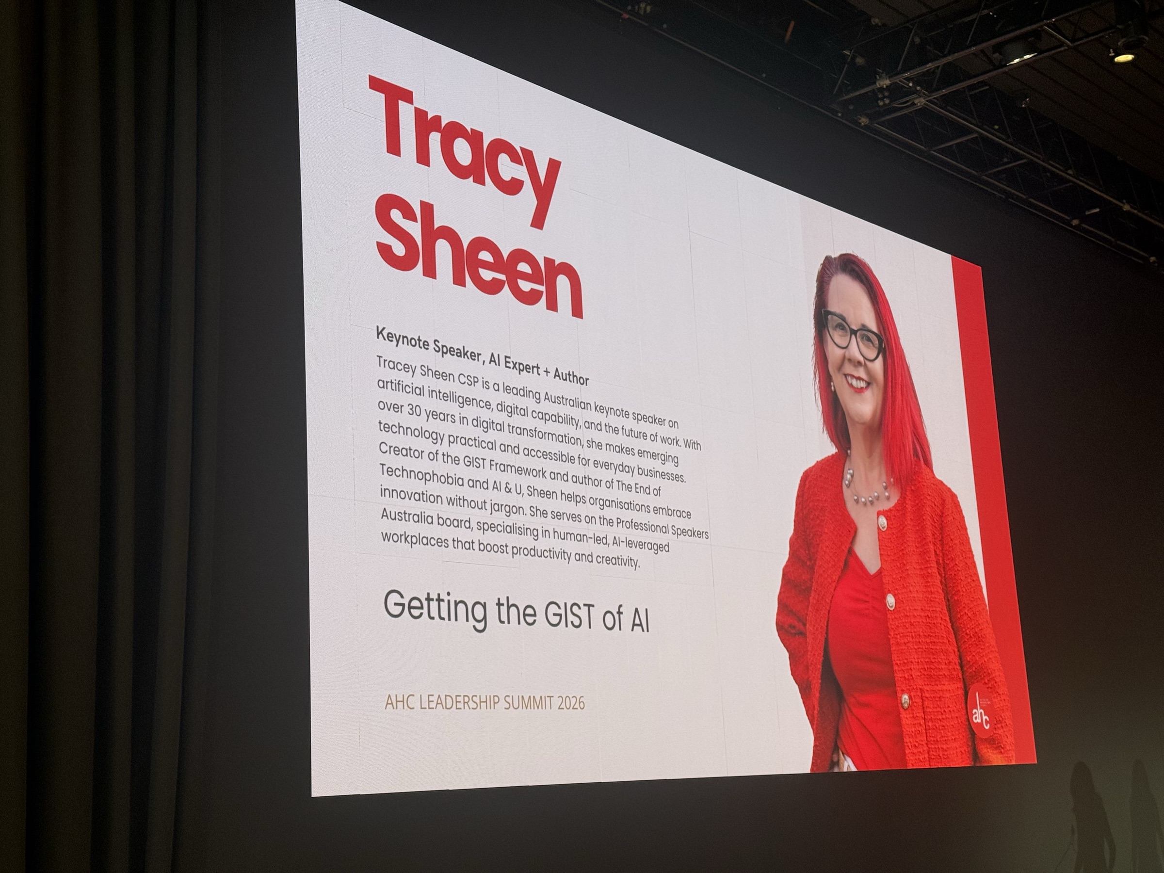 Tracy Sheen delivering the Getting the GIST of AI keynote on stage at the AHC Leadership Summit