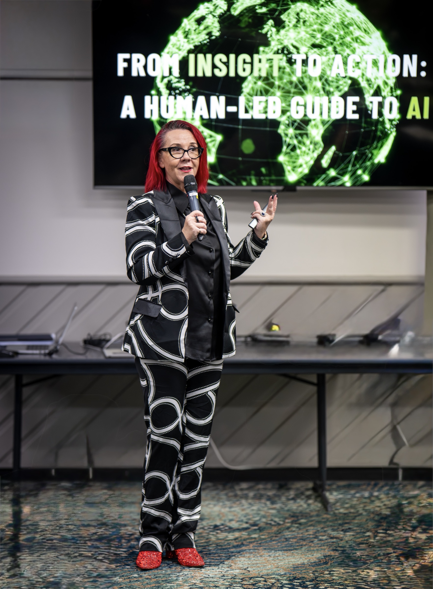 Tracy Sheen presenting the keynote at the Western Downs Business Summit with the Human-led slide on screen behind her
