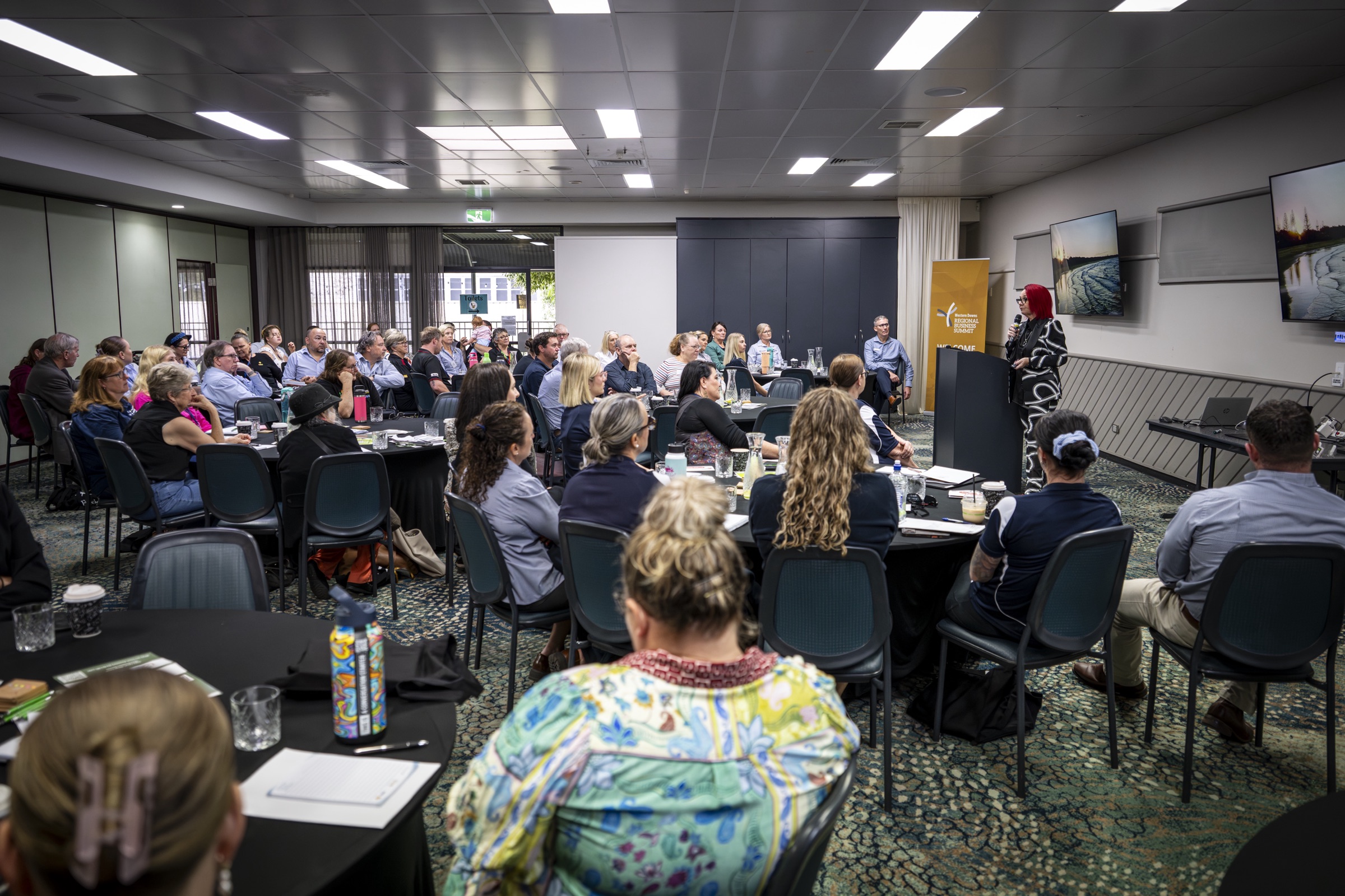 Business owners at tables during the AI and U Reimagine Business workshop in Chinchilla
